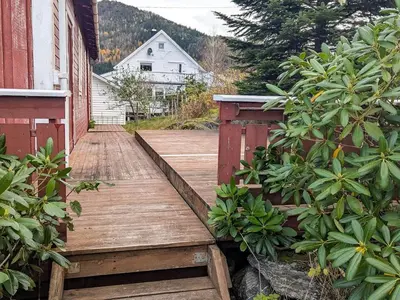 a wooden walkway in a yard with a house at 8 person holiday home in isfjorden-By Traum in Torvik