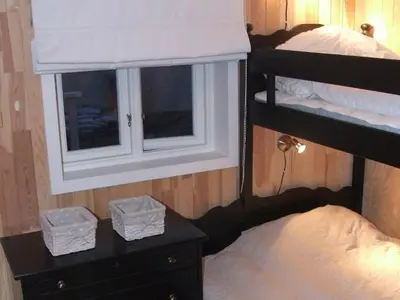 a bedroom with two bunk beds and a window at 9 person holiday home in GURSKØY-By Traum in Kjellsund