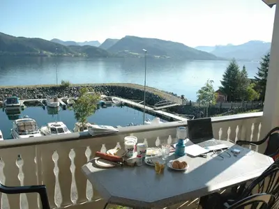 a balcony with a table with a laptop on it at 4 person holiday home in Lauvstad-By Traum in Lauvstad