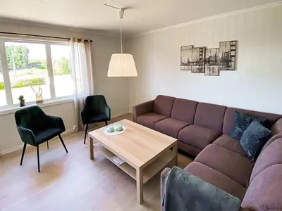a living room with a couch and a table at 11 person holiday home in VEVANG-By Traum in Vevang