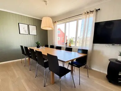 a dining room with a large wooden table and chairs at 11 person holiday home in VEVANG-By Traum in Vevang