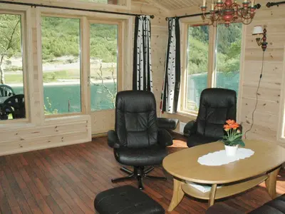 a living room with a table and chairs and windows at 4 person holiday home in olden-By Traum in Olden