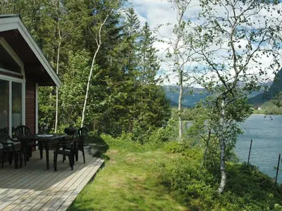 a porch of a house with a table and chairs at 4 person holiday home in olden-By Traum in Olden