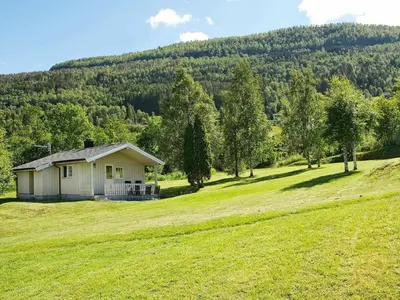a small house on a hill in a field at 4 person holiday home in Utvik-By Traum in Reed
