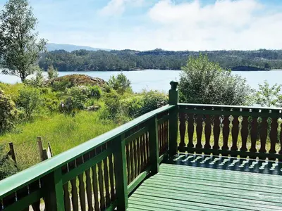a wooden deck with a view of a lake at 10 person holiday home in HOSTELAND-By Traum in Hosteland