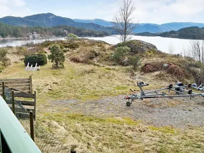 a field with a view of a body of water at 10 person holiday home in HOSTELAND-By Traum in Hosteland