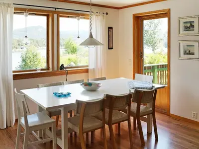 a dining room with a white table and chairs at 10 person holiday home in HOSTELAND-By Traum in Hosteland