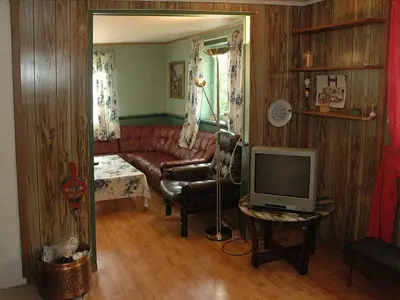 a living room with a red couch and a television at 8 person holiday home in Åfarnes-By Traum in Årset
