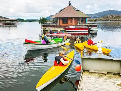 a group of people in kayaks on a lake at 6 person holiday home in Kalvåg-By Traum in Kalvåg