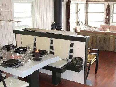 a dining room with a table with a candle on it at 8 person holiday home in Kalvåg-By Traum in Kalvåg
