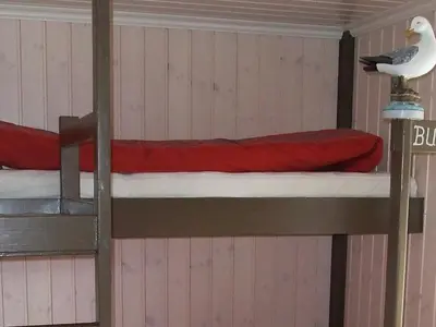 a room with two bunk beds with a seagull on the wall at 8 person holiday home in Kalvåg-By Traum in Kalvåg