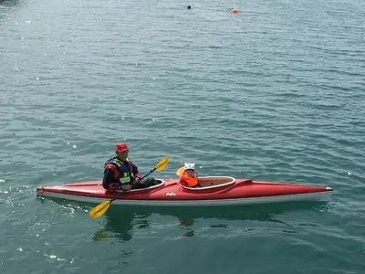 two people in a red kayak in the water at 8 person holiday home in Kalvåg-By Traum in Kalvåg