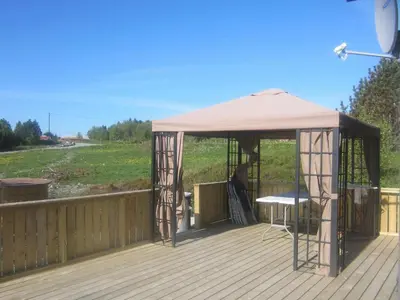 a gazebo with a table on a wooden deck at 6 person holiday home in Storfosna-By Traum in Sletta