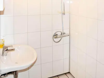 a white bathroom with a sink and a shower at 6 person holiday home in Oksvoll-By Traum in Oksvoll
