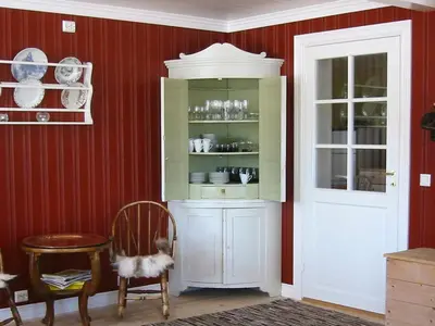 a dining room with a cabinet and a chair at 10 person holiday home in Follafoss-By Traum in Vølset