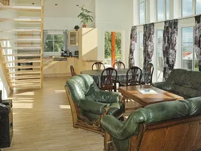 a living room with leather furniture and a table at 8 person holiday home in VEVANG-By Traum in Vevang