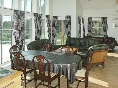a living room with a table and a couch at 8 person holiday home in VEVANG-By Traum in Vevang