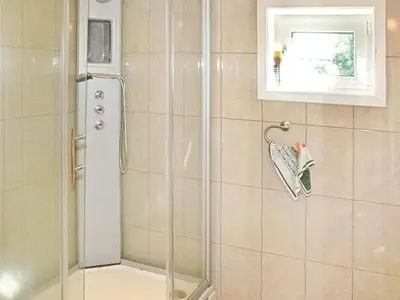 a shower with a glass door in a bathroom at 5 person holiday home in VEVANG-By Traum in Vevang