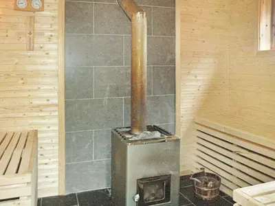 a woodburning stove in a room in a sauna at 5 person holiday home in VEVANG-By Traum in Vevang