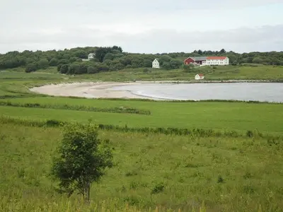 a large body of water with a house in a field at 5 person holiday home in VEVANG-By Traum in Vevang