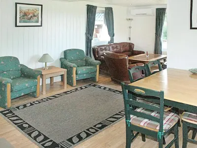 a living room with couches chairs and a table at 5 person holiday home in VEVANG-By Traum in Vevang
