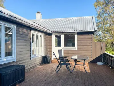a patio with a table and chairs on a house at 3 person holiday home in Frei-By Traum in Frei