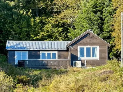 a small house on a hill with trees at 3 person holiday home in Frei-By Traum in Frei