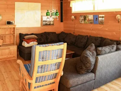 a living room with a couch and a chair at 12 person holiday home in Kvenvær in Kvenvær