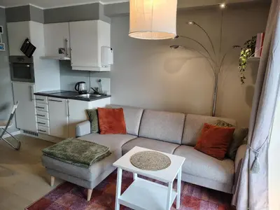 a living room with a couch and a table at Oppheim Holiday Apartment in Øyjordi