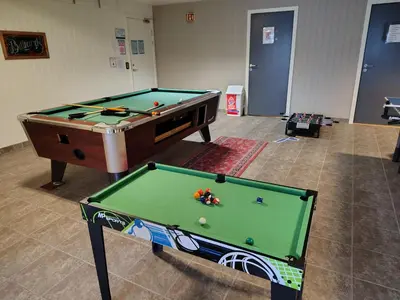 a room with a pool table and a table at Oppheim Holiday Apartment in Øyjordi