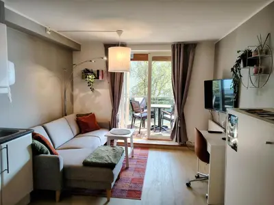 a living room with a couch and a table at Oppheim Holiday Apartment in Øyjordi