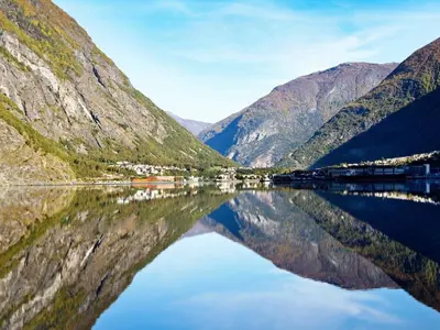 a reflection of mountains in a body of water at 6 person holiday home in Øvre Årdal in Øvre Årdal