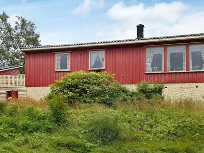a red house with a red at 6 person holiday home in Halsanaustan in Korsnes