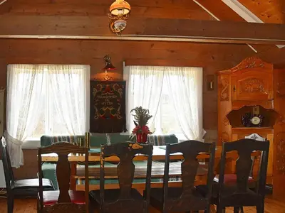 a dining room with a table and chairs and windows at 10 person holiday home in Bygstad in Bygstad