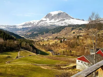 a snow covered mountain in the middle of a field at 10 person holiday home in Bygstad in Bygstad