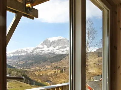 a window with a view of a snow covered mountain at 10 person holiday home in Bygstad in Bygstad
