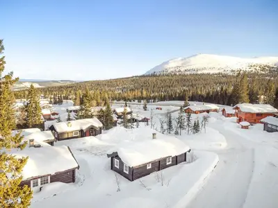 a village covered in snow with a mountain in the background at Trysilfjellet Nord 356 A and B in Trysil