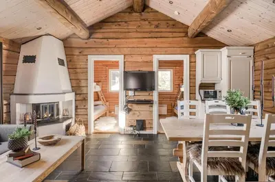 a living room with a table and a fireplace at Trysilfjellet Nord 356 A and B in Trysil