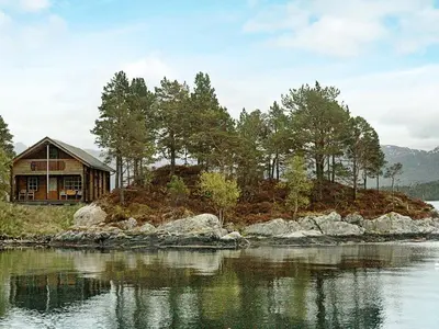 a house on a small island in the water at 5 person holiday home in VÅGLAND in Bårdset