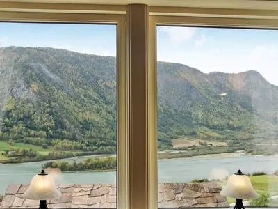 a window with a view of a river and mountains at 6 person holiday home in Otta in Otta