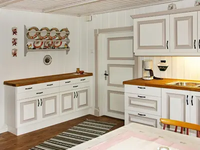 a kitchen with white cabinets and a sink at 6 person holiday home in Otta in Otta