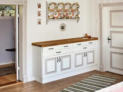 a kitchen with white cabinets and a wooden counter at 6 person holiday home in Otta in Otta