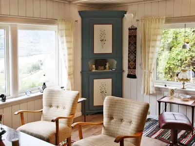 a room with two chairs and a table and two windows at 6 person holiday home in Otta in Otta