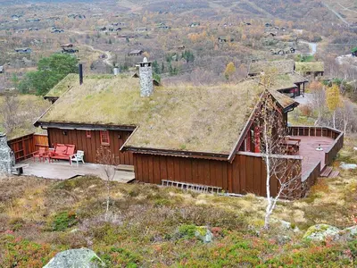 a house with a grass roof on a hill at 11 person holiday home in Edland in Vågsli