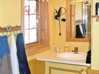 a bathroom with a sink and a mirror at 11 person holiday home in Edland in Vågsli