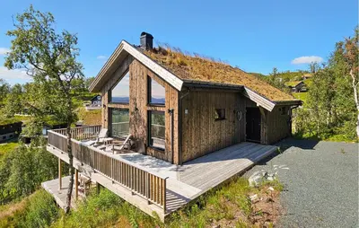 a house with a deck with a grass roof at Cozy Home In Rauland With Sauna in Rauland