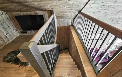 a spiral staircase in a house with a tv at Cozy Home In Rauland With Sauna in Rauland