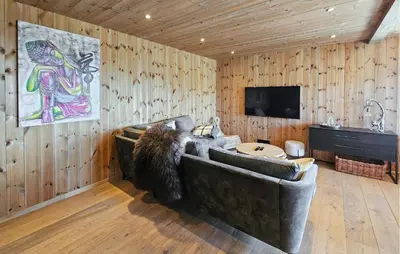 a living room with a couch and a flat screen tv at Cozy Home In Rauland With Sauna in Rauland