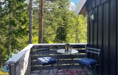 a patio with a table and two chairs on a deck at Cozy Home In Vinje With Wifi in Hommo