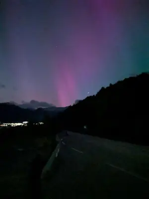 a rainbow in the sky over a road at night at Apartment Fjordblick in Leikanger